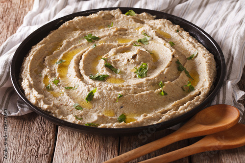 Middle Eastern cuisine: baba ghanoush closeup in a plate. horizontal
