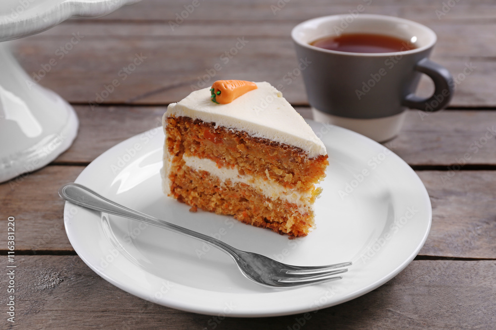 Delicious carrot cake with tea on wooden table Delicious carrot cake with tea on wooden table