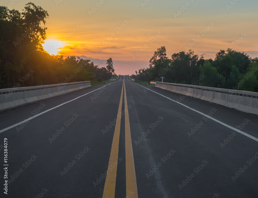 Driving on the road at sunset