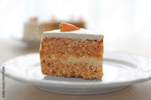 Tasty slice of carrot cake on white plate