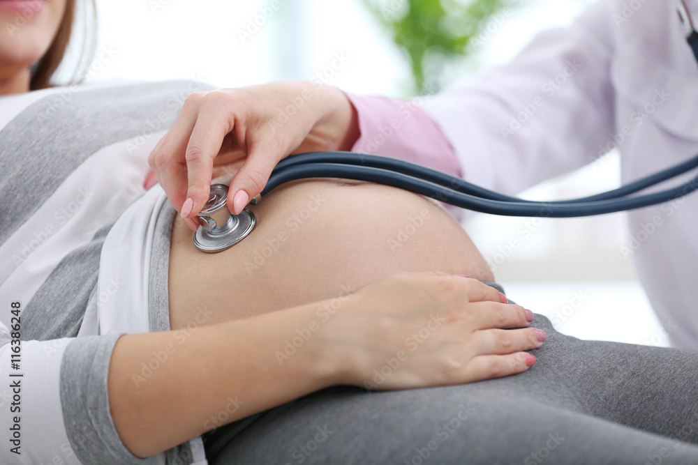 Doctor examining the pregnant woman Doctor examining the pregnant woman