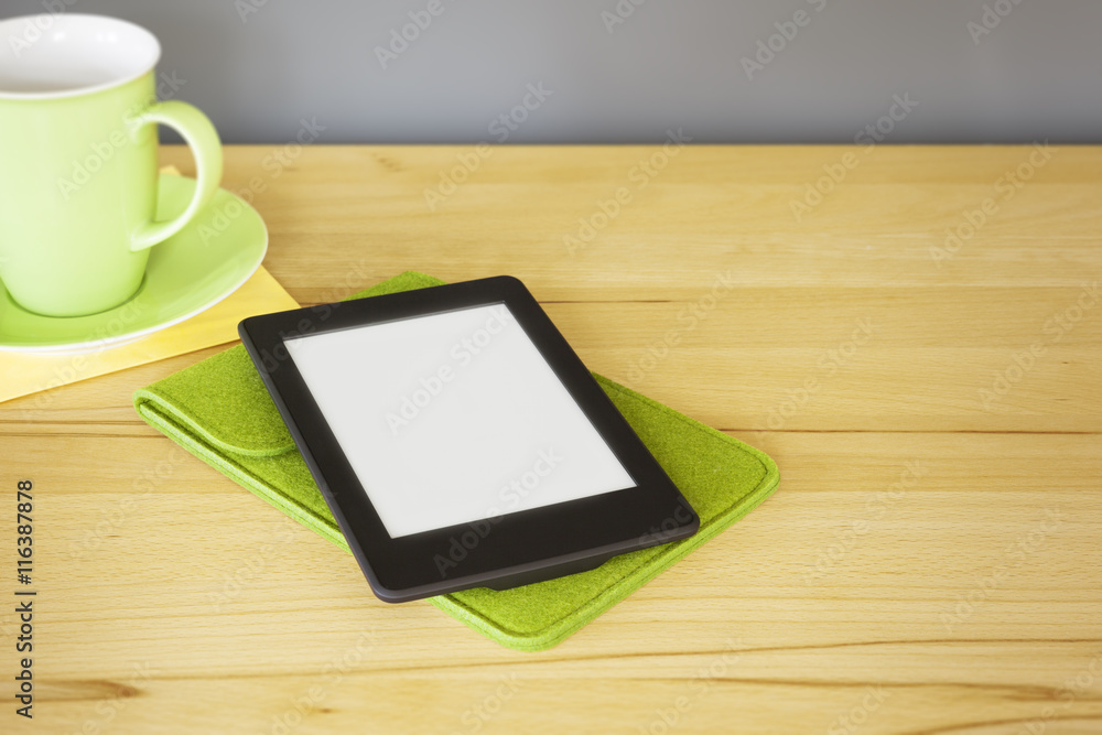 ebook reader on a wooden table ebook reader on a wooden table