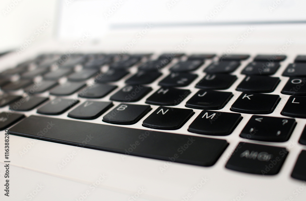 White office laptop keyboard with black buttons White office laptop keyboard with black buttons