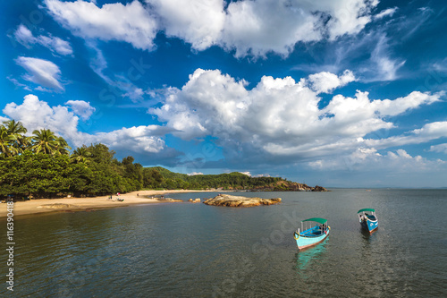 Vacant tourist sea trip boats in the tranquil waters of Om beach in Gokarna, India photo