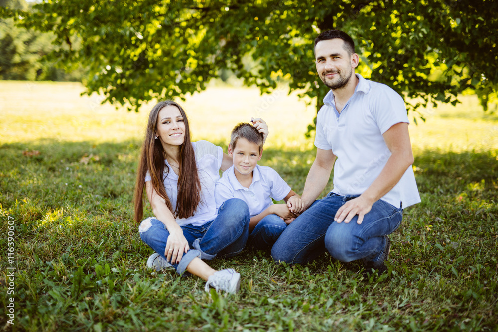 Family of Three Having Fun Together in a Field.Concept of friendly family. Family of Three Having Fun Together in a Field.Concept of friendly family.