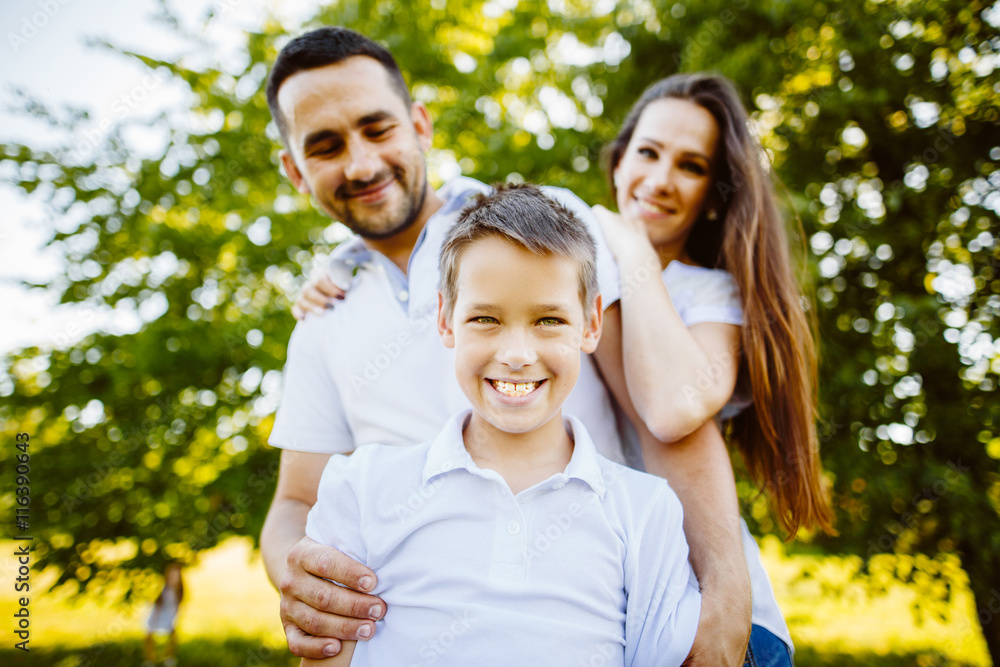 Family of Three Having Fun Together in a Field.Concept of friendly family. Family of Three Having Fun Together in a Field.Concept of friendly family.