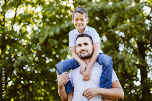 Father and son having fun in summer park