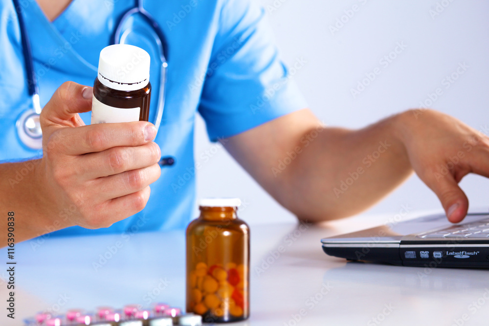 the doctor writes a prescription pill on the computer the doctor writes a prescription pill on the computer