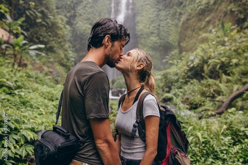 Couple in love kissing near a waterfall in forest © Jacob Lund