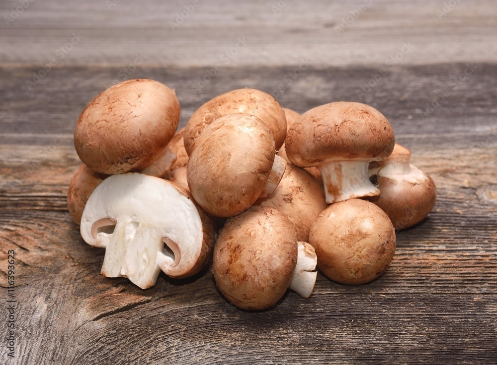 Brown champignon on wooden background Brown champignon on wooden background