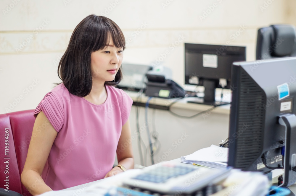Asians women working at computer in an office. Asians women working at computer in an office.