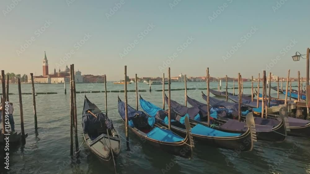 Parking gandolas on the Doge's palace embankment with the bell tower of the Saint Giorgio Maggiore church view. Parking gandolas on the Doge's palace embankment with the bell tower of the Saint Giorgio Maggiore church view.
