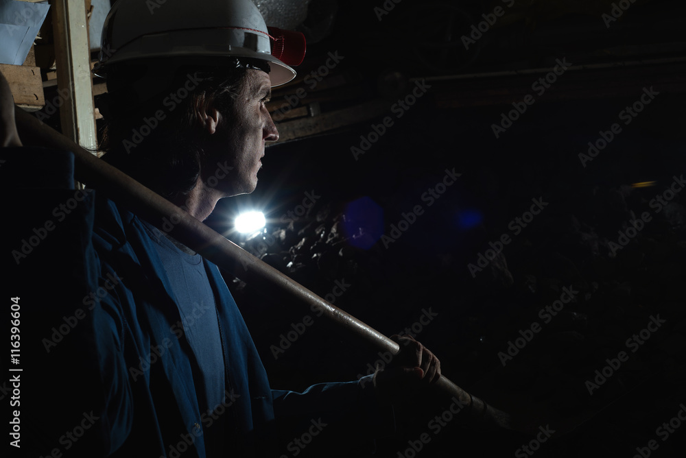 miner shoveling the coal 