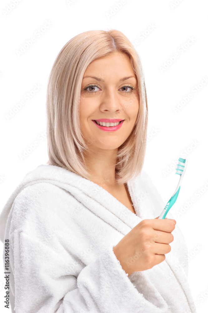 Woman in bathrobe holding toothbrush Woman in bathrobe holding toothbrush
