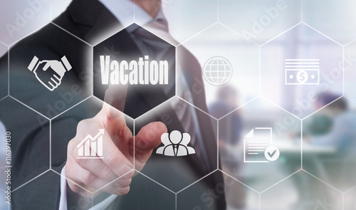 A businessman selecting a Vacation Concept button on a hexagonal screen
