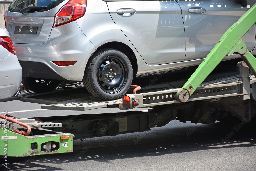 Fototapeta premium New car on the trailer vehicle