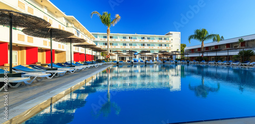 Space by pool with sun loungers and childrens playground with slides