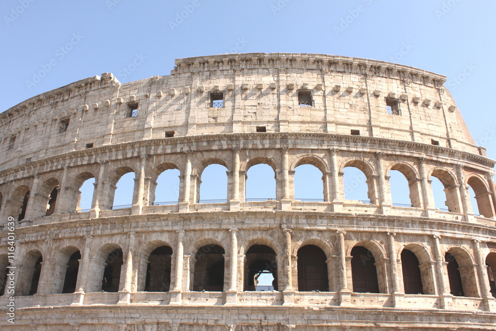 Great Colosseum in Rome, Italy, Europe. Roman Coliseum close-up with clear blue sky.