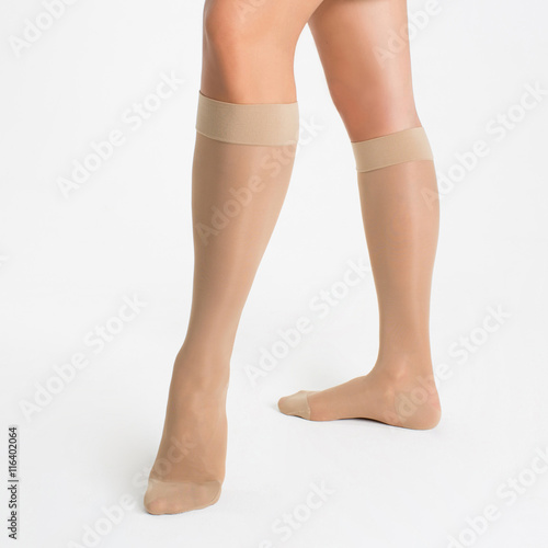 Female legs in socks on white background