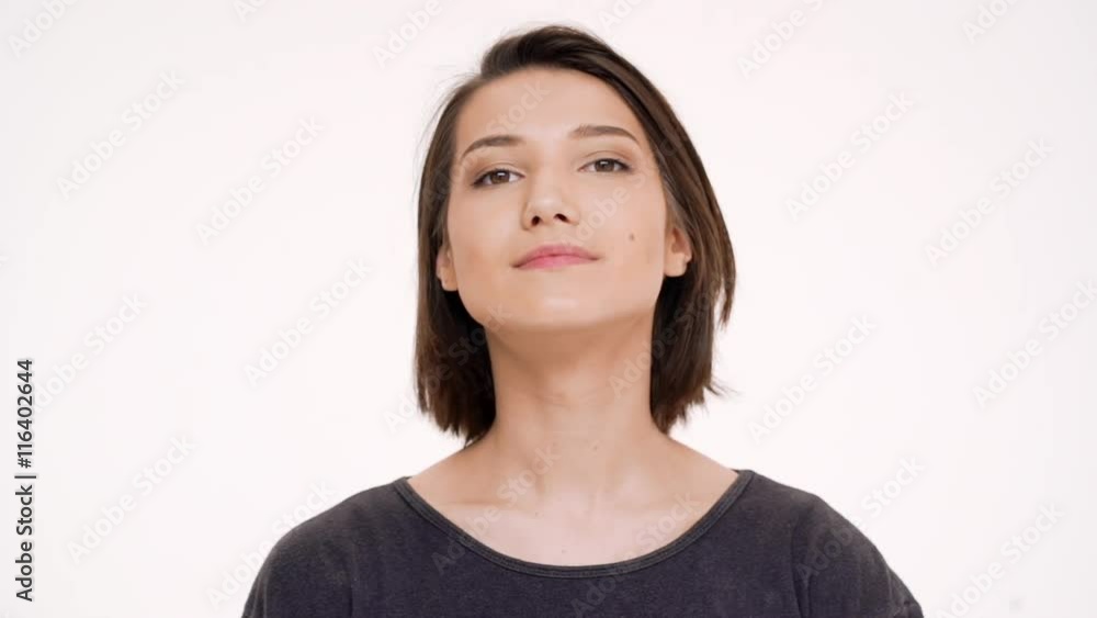 Portrait of young pretty girl correcting hair. Slow motion. Portrait of young pretty girl correcting hair. Slow motion.