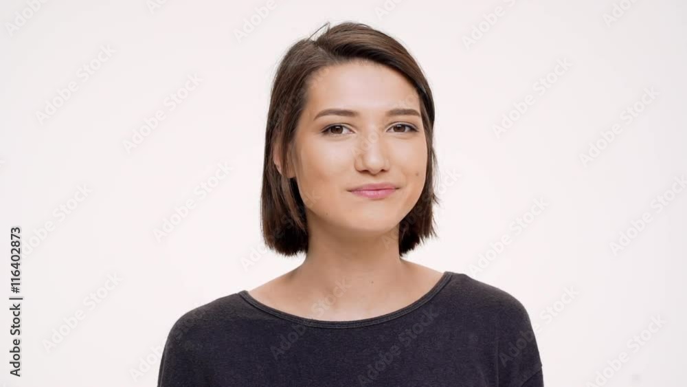 Portrait of young pretty girl clicking finger and winking. Slow motion. Portrait of young pretty girl clicking finger and winking. Slow motion.