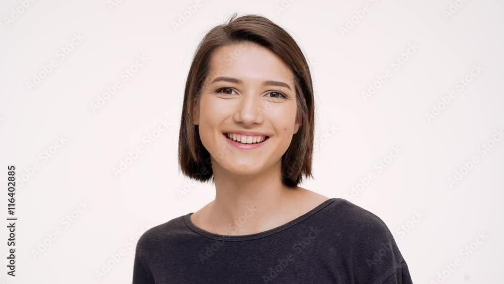 Portrait of young pretty girl clicking finger and winking. Slow motion. Portrait of young pretty girl clicking finger and winking. Slow motion.