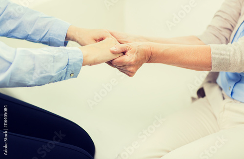 close up of senior and young woman hands