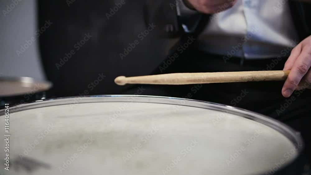 Man in black suit and sunglasses plays on drum. Rock cover band performing on stage with drummer Man in black suit and sunglasses plays on drum. Rock cover band performing on stage with drummer