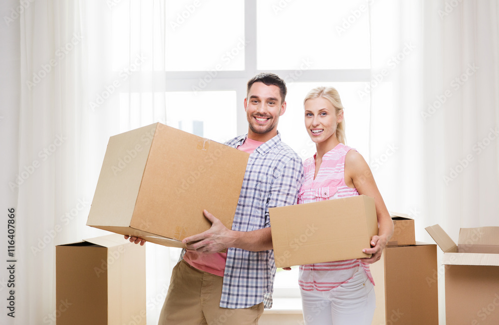 couple with big cardboard boxes moving to new home couple with big cardboard boxes moving to new home