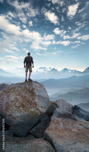 Winner silhouette on the mountain top. Sport and active life concept..