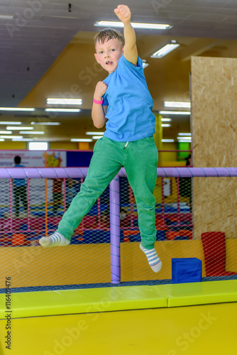 Exuberant young boy bouncing on a trampoline