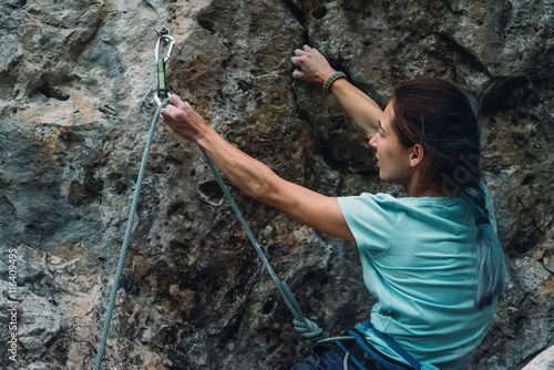 Climber with rope and quickdraw photo