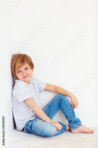 handsome young boy, kid posing near the white wall