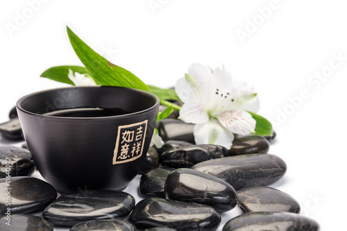 Tea cup with stones and flower landscape composition