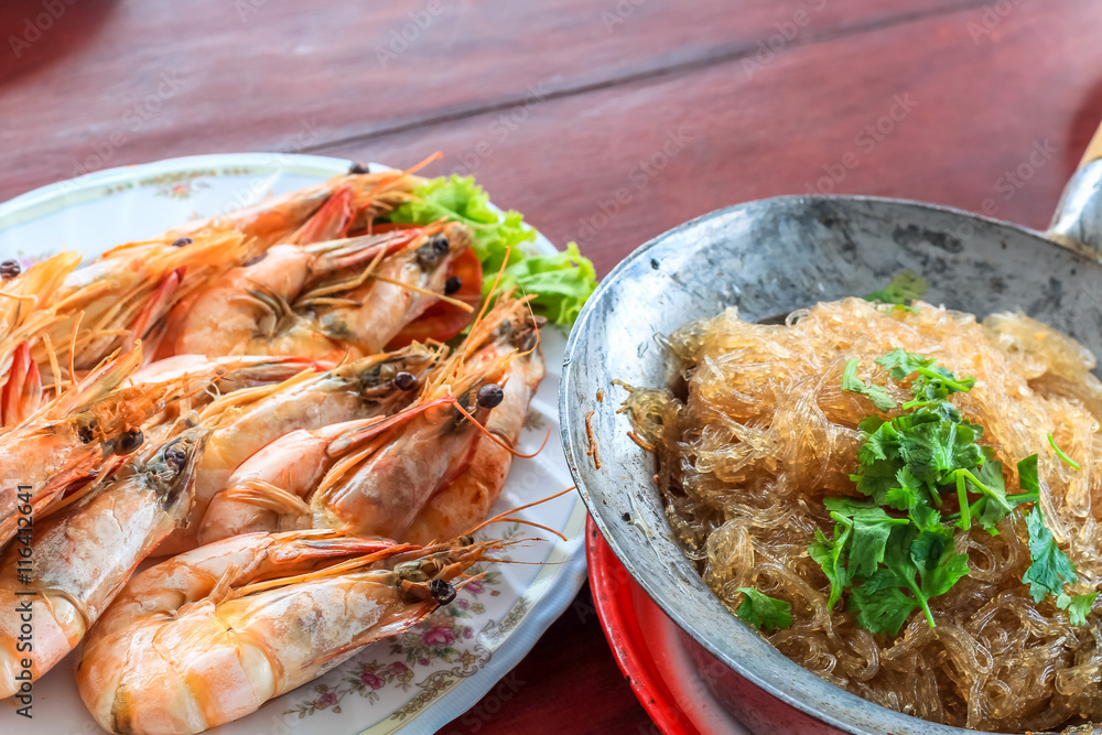 Top view steamed shrimp/prawn in the white plate and shrimps vermicelli with glass noodles in hot pot ready to eat Top view steamed shrimp/prawn in the white plate and shrimps vermicelli with glass noodles in hot pot ready to eat