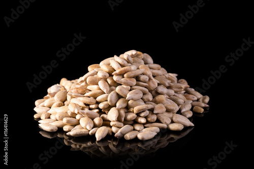 Fotografie Sunflower seed kernels Sunflower seeds on black background