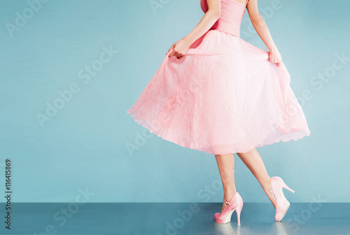 Print op canvas Romantic pink dress with pink shoes on vintage look blue background