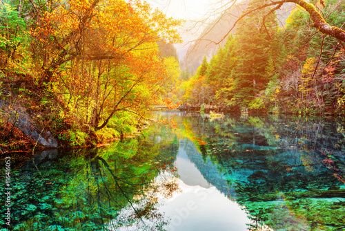 The Five Flower Lake. Colorful fall woods reflected in water
