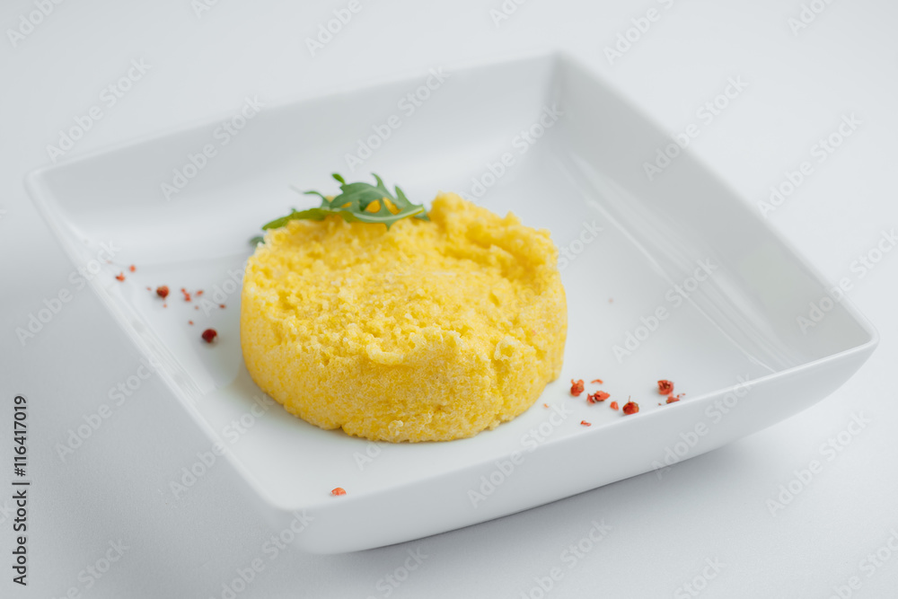 millet porridge with arugula on a white plate millet porridge with arugula on a white plate