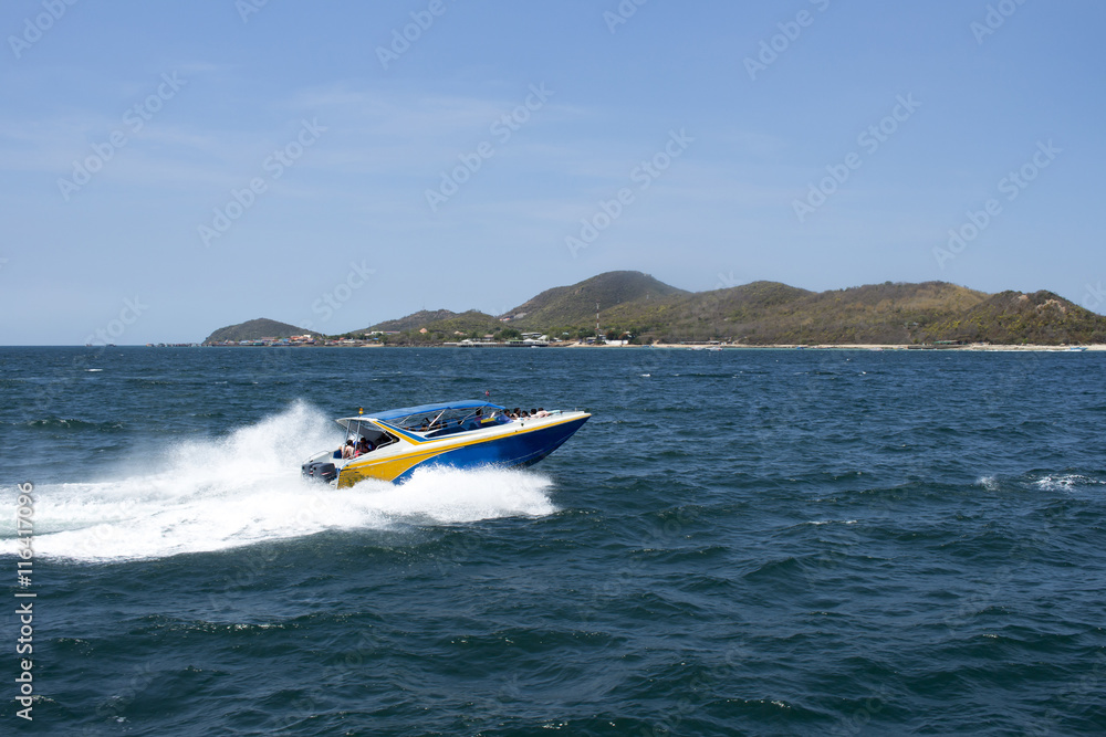 Fototapeta premium speed boat driving to island, blurred passenger