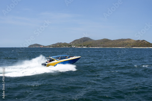 speed boat driving to island, blurred passenger © mckaphoto