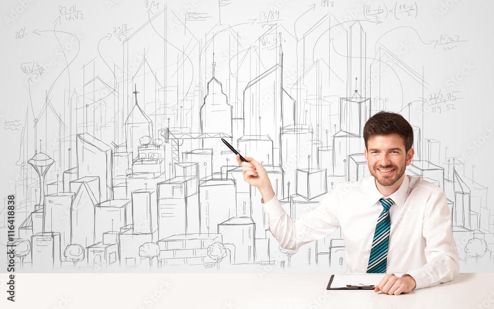 Businessman sitting at the white table with hand drawn buildings