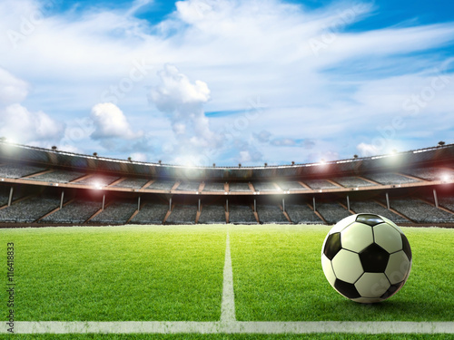Fototapeta piłka z tłem stadionu piłkarskiego