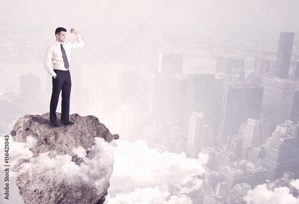 Winner business person standing on rock Winner business person standing on rock
