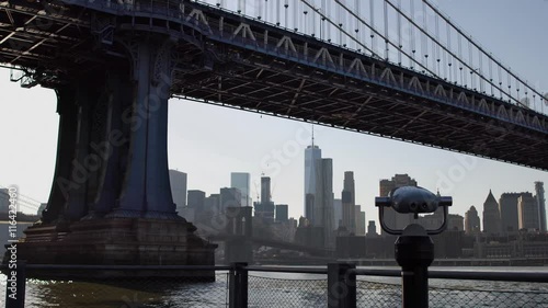 Tourist binoculars at Manhattan bridge. Manhattan skyline on background.