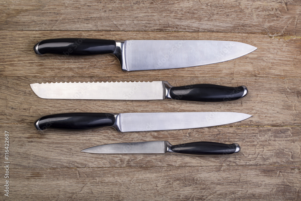 Fototapeta premium kitchen knifes on wooden board