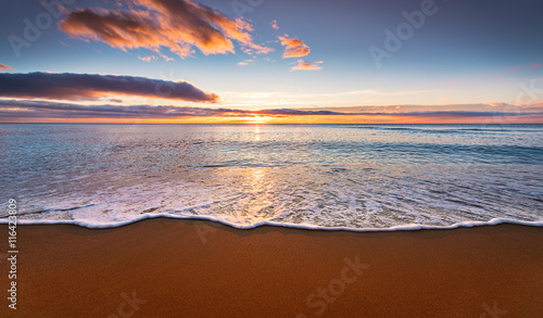 Colorful seaside beach sunrise.