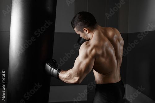 Young boxer trains on punching bag © IEGOR LIASHENKO