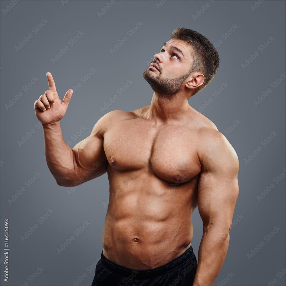 Portrait of muscular man who is pointing a finger up Stock Photo | Adobe  Stock