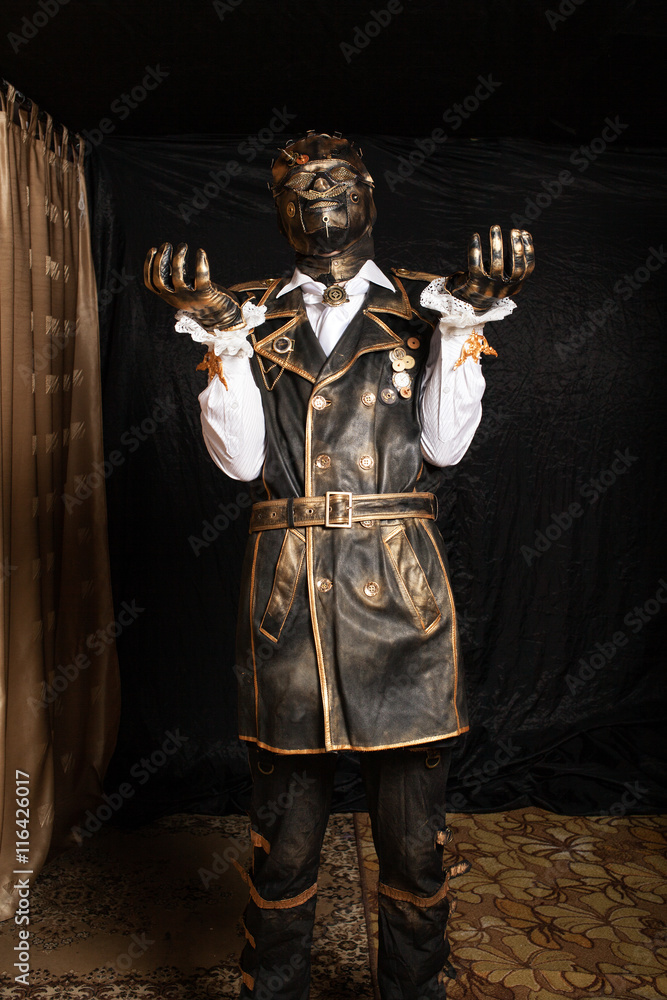 Fototapeta premium Man in a mask in a cyborg costume against black background